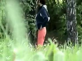 Woman looking for place to pee outdoors