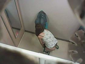 Gorgeous brunette caught changing clothes in the dressing room