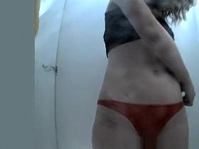 Girl puts her red bikini on