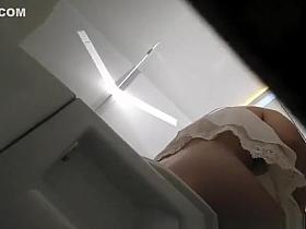 Woman caught seated in public toilet