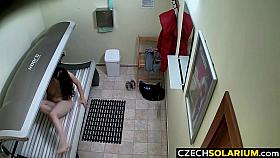 Busty MILF rubbing her pussy in Solarium