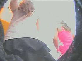 Two cuties stalked around by an upskirt voyeur