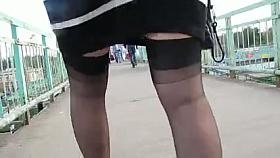 Girl in ff-stockings going upsairs on a train station.