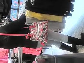 Woman in tight jeans pants at clothes store