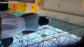 Sexy brunette reveals a nice ass under her pleated skirt in