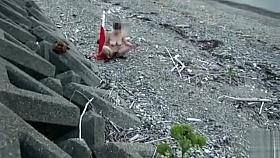 Amateur woman sits on traffic cone at the beach