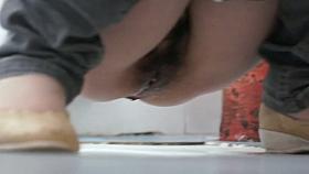 Asian chick pissing in a squatting toilet while being spy cammed