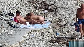 Couple fucked on a public beach while as people walked near