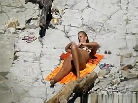 Long hair nudist with big ass and small tits sunbathing