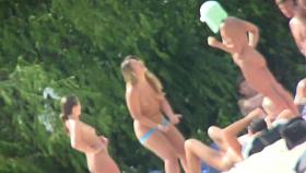 A group of girls showing off their naked bodies at the beach