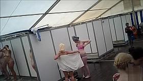 Dozens of actresses shower in tented locker area