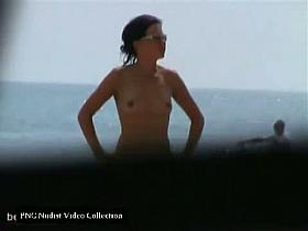 Trimmed pussy, small natural boobs, black hair at the nudist beach