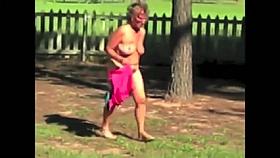 Older Female Disrobes outdoors