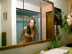 Attractive lady takes off her clothes in this voyeur solo video