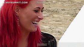 Redhead girl, with big boobs in neckline.