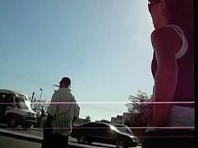 A brunette teen waiting in the street while being spy cammed