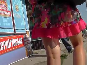 Woman in red short skirt with nice legs upskirted