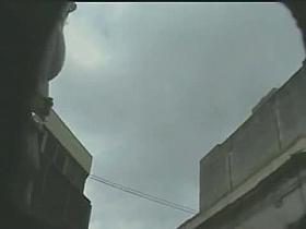 Cute lady in a pretty dress is filmed with a naked ass