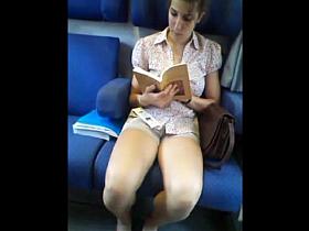girl very nice in shorts reading in train