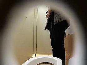 Woman pisses in toilet