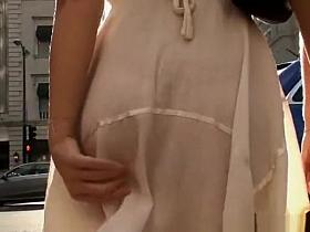 Brunette girl in white dress walking