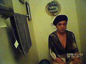 A thick woman with big tits pissing in the public restroom