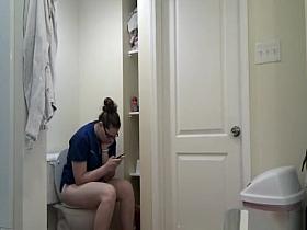 Chubby girl in glasses taking a long pee