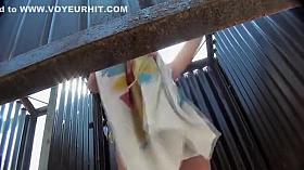 Peeping on her pierced belly and tits