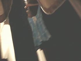 A girl changing clothes and getting naked in front of a huge wardrobe with a mirror