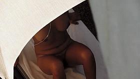 Curvy woman with a hairy labia relaxes under an umbrella