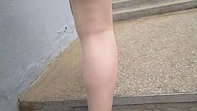 Girl in tan stockings going upstairs