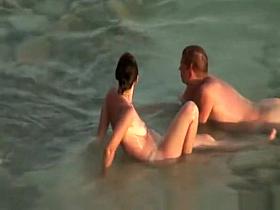 Hairy pussy nudist with glasses in the water