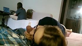 Girlfriend gives a blowjob while her sister is in same room
