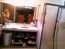 Busty blonde brushes her hair and takes a shower