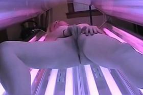 Tanning room spycam - blonde rubs it