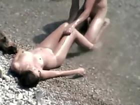 He covers her with sand for a blowjob