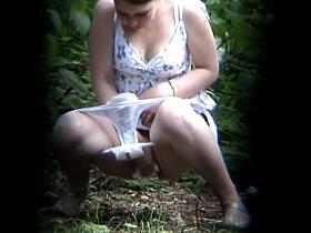 A menstruating woman pissing in the forest