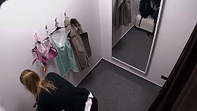 Woman struggles to put her bikini top