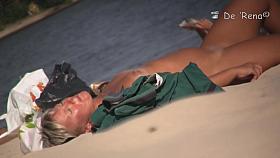 Beach voyeur man enjoys the view of topless female tits