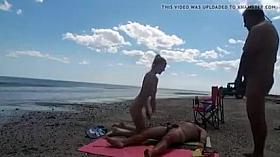 Nudist wife jerks off strangers at the beach and they cum on her