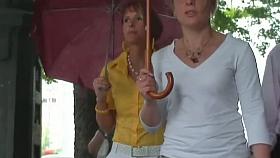 Classy blonde in heels and white pants in a street candid vid