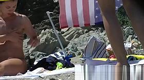 Some teen and mature couples resting at the nudist beach