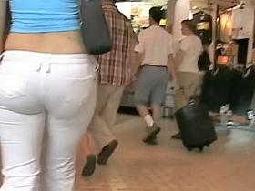 Tight bodied brunette's lush ass caught on a candid cam