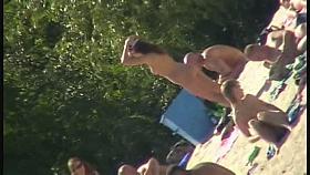 Hot brunette bares it all to the nudist beach voyeur