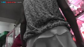 Upskirting slender young girl in white panties