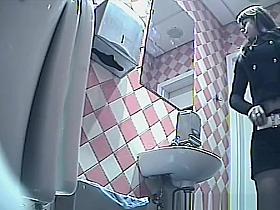 Girl in shorts pees in toilet