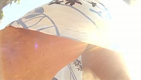 Curvy brunette's juicy ass exposed by an upskirt cam