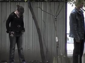 Girl in glasses caught peeing outdoors