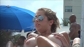 Topless beach girl with massive tits