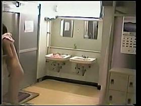 A naked factory girl is wiping herself after shower